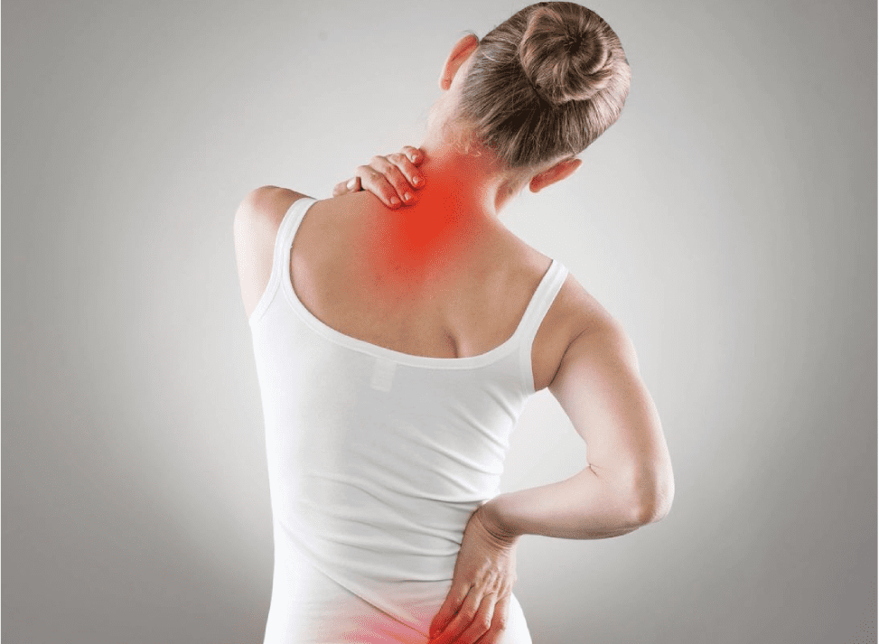 A woman with her back turned and neck in pain.